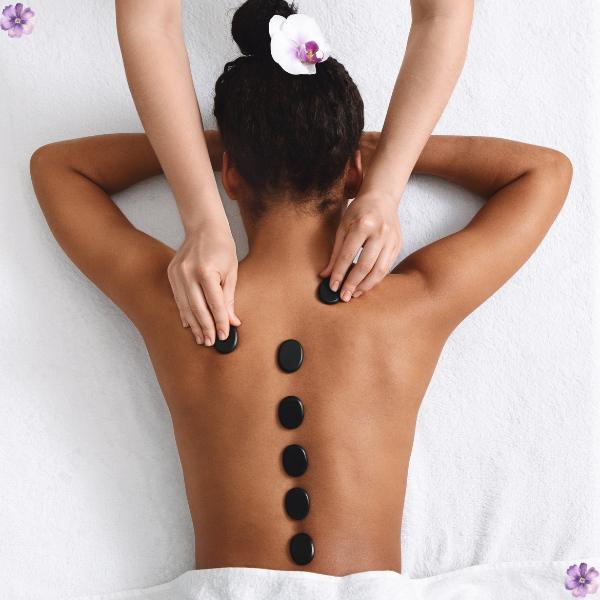 A woman gets a massage with hot stones.